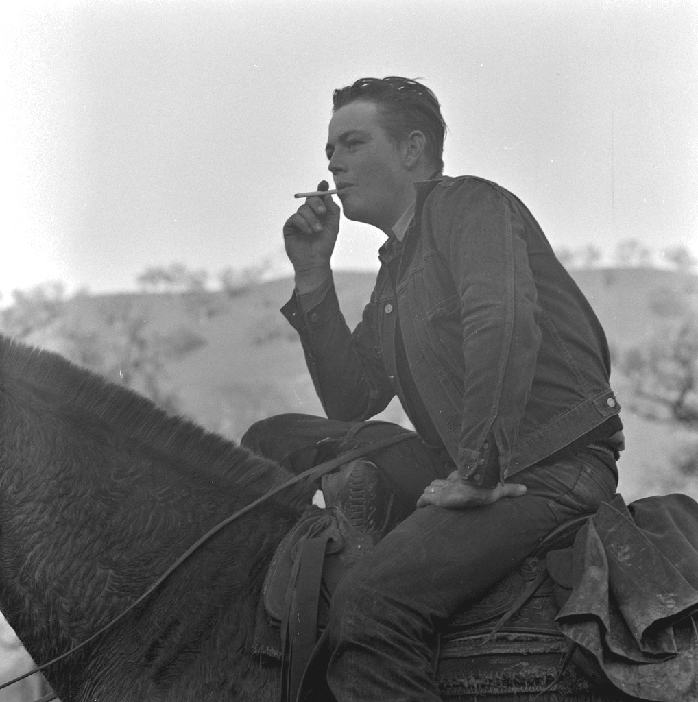A man on horseback in work clothes