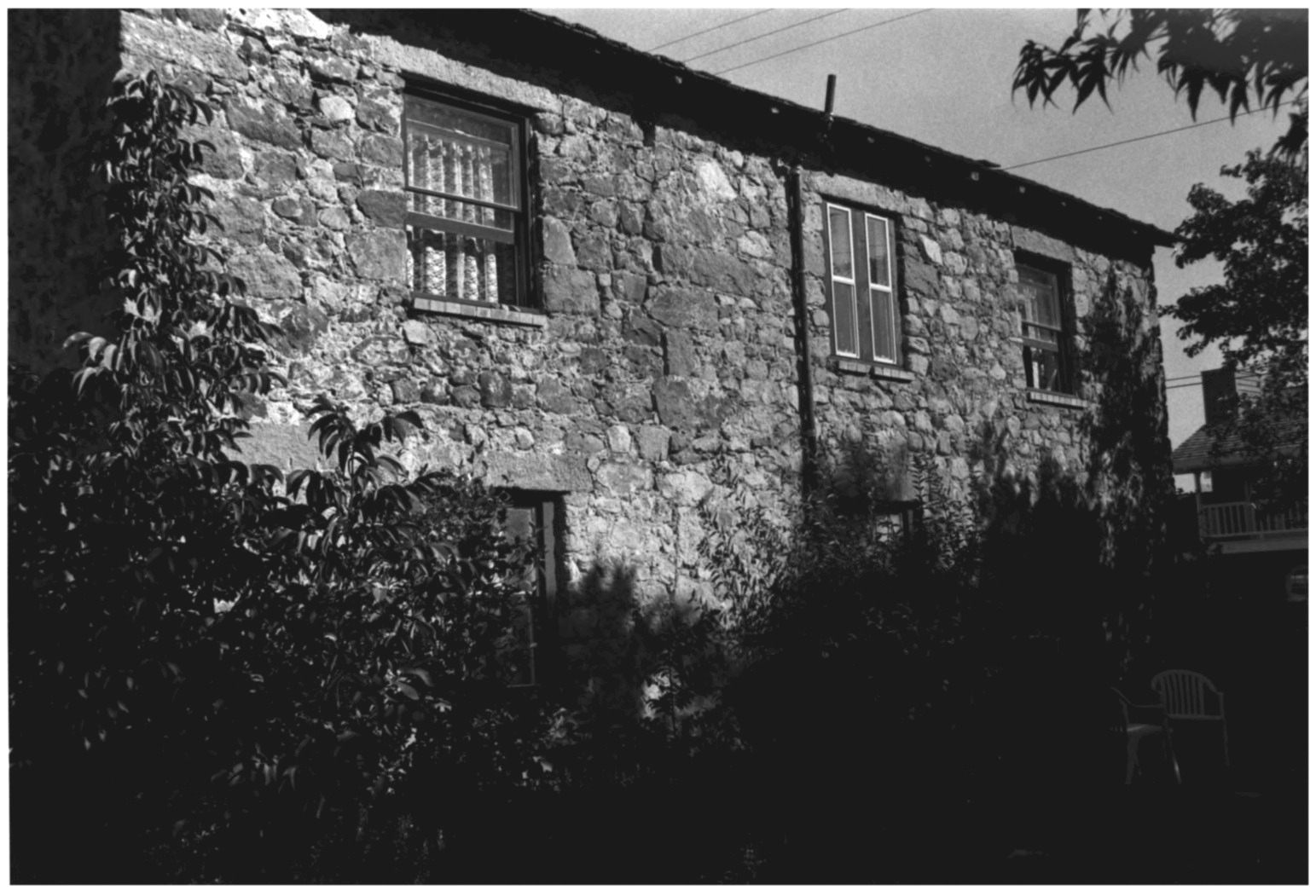 The stone house of Charles Rovegno in shadow